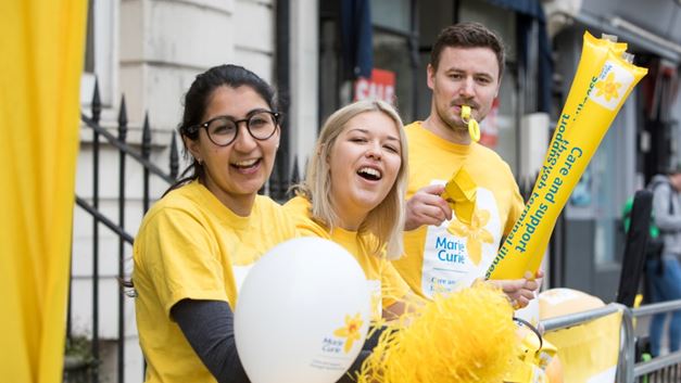 Marie Curie fundraising team cheering at an event