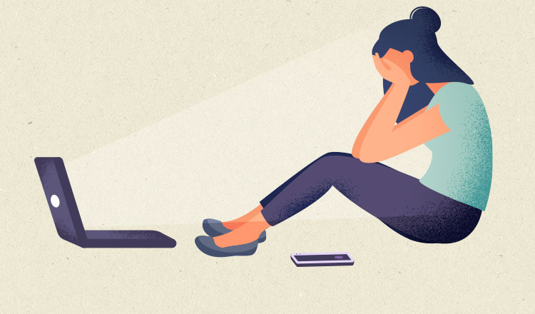 Employee sitting in front of laptop with head in hands