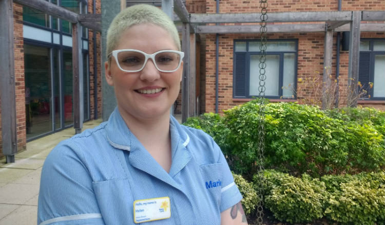 Marie Curie Nurse Helen Bowen outside the entrance to the Marie Curie Hospice, West Midlands