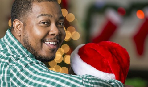 Dad and child on a sofa at Christmas