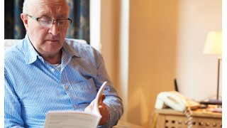 Man reading booklet