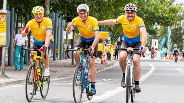 A group of men cycling in Marie Curie jerseys