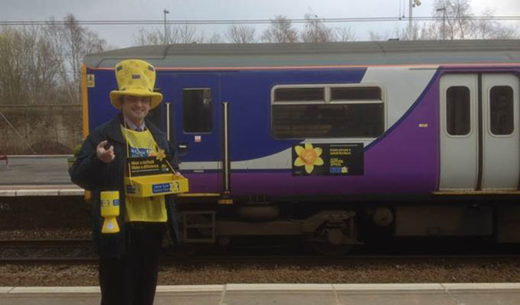 Marie Curie collector with a Northern Rail train