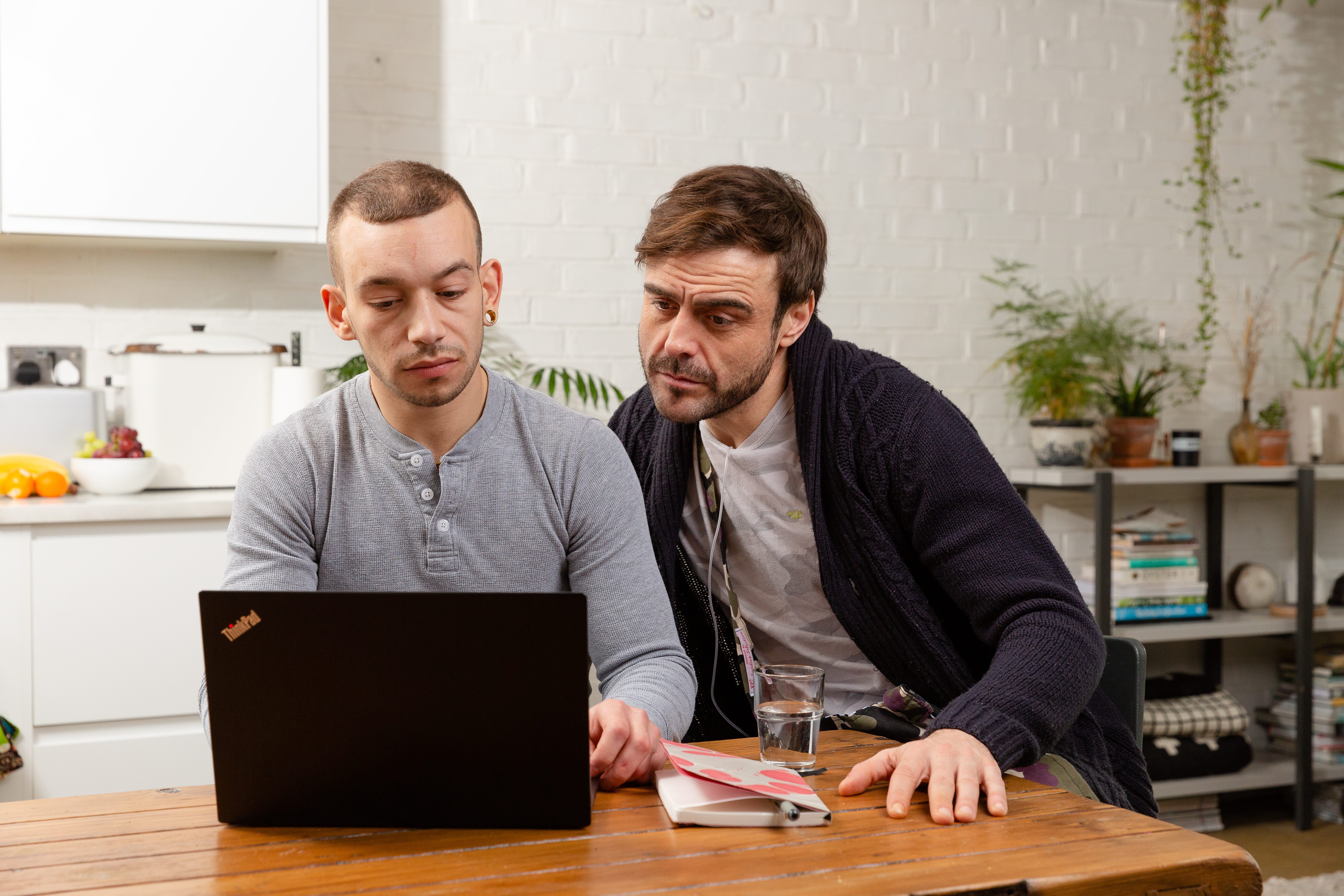 Two men looking at laptop